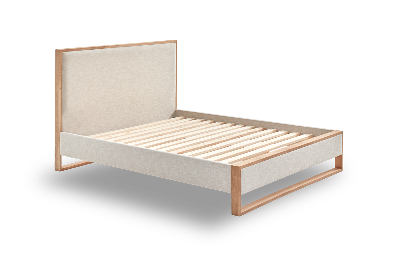 Oak wood bed frame with a light fabric headboard and slats.